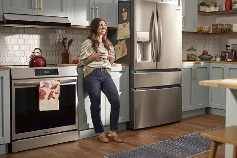Frigidaire Induction Range with Total Convection, showing happy user experience in a stylish kitchen.